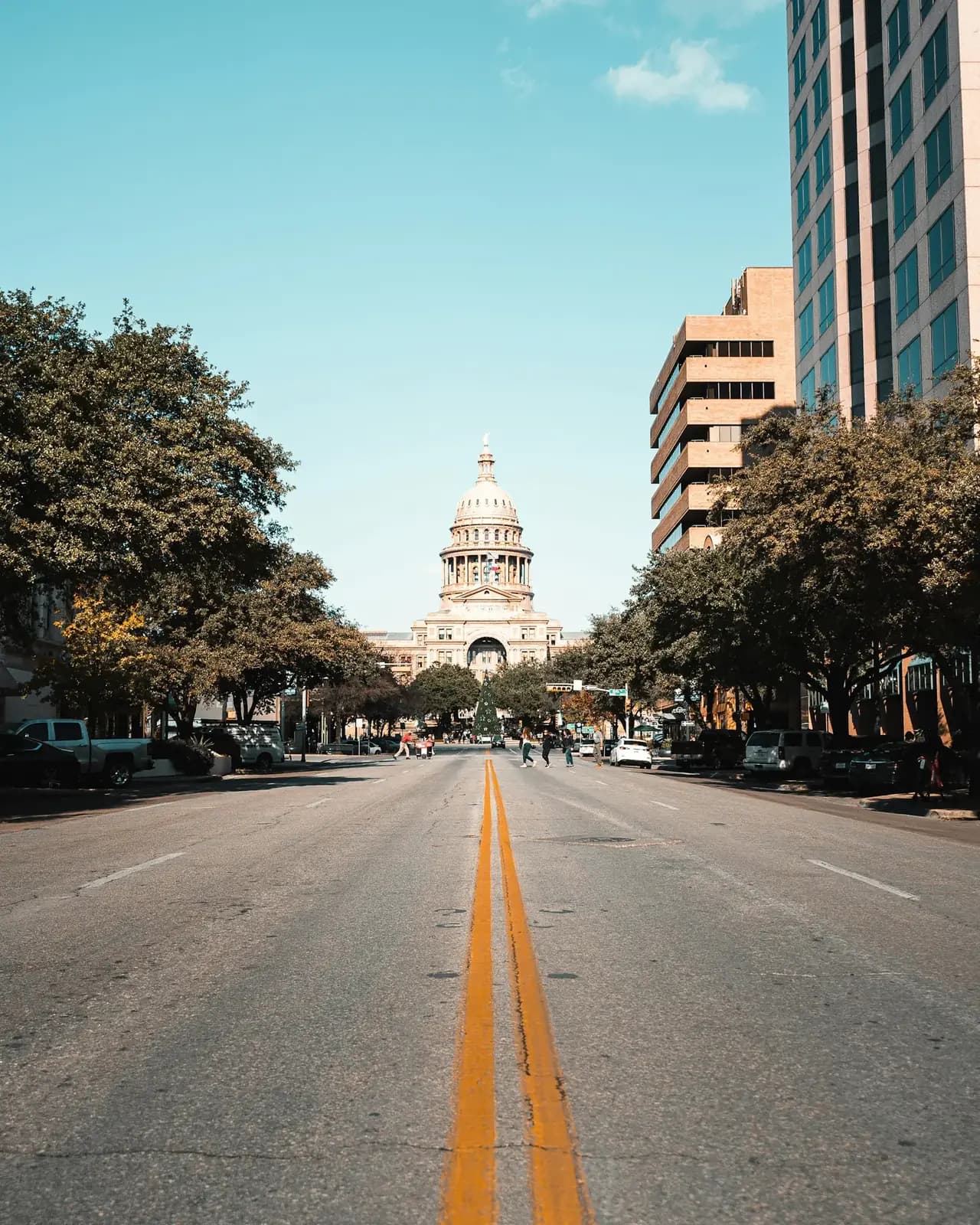 Congress Avenue leading toward the Texas Capitol beneath Austin trees